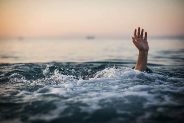 istock Hand of a sinking man in water 1033985284
