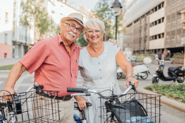 istock Senior couple with bicycles hugging 1033985444