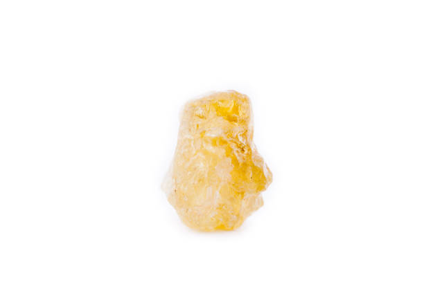 istock Macro mineral stone Granat (grossular) yellow green on a white background 1033988054