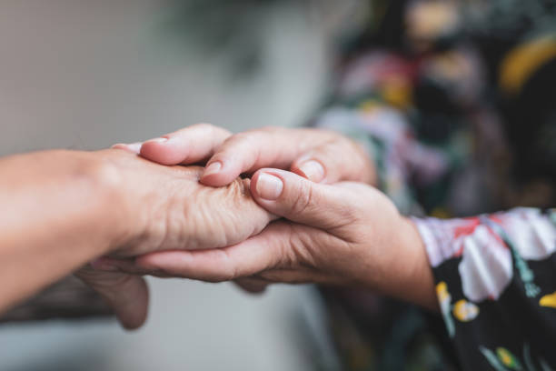 istock Female hands holding another hand 1034003360