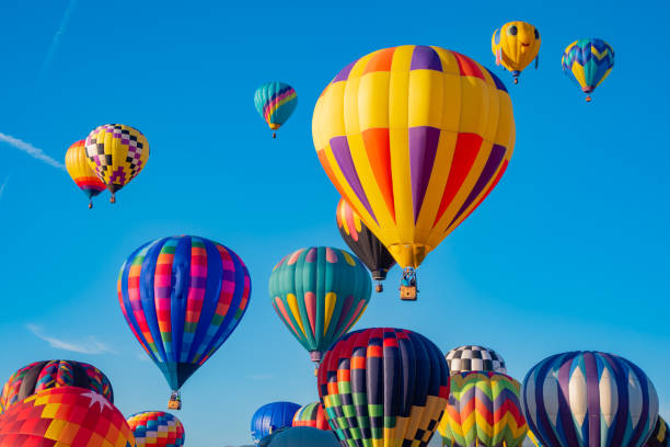 Sky full of hot air balloons Many hot air balloons fill the blue sky. ballooning festival stock pictures, royalty-free photos & images