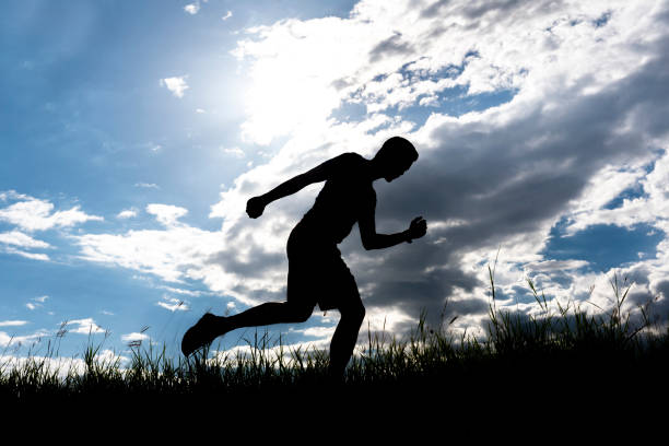 istock Men running outdoor on silhouette background. 1034027090