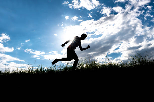istock Men running outdoor on silhouette background. 1034027094