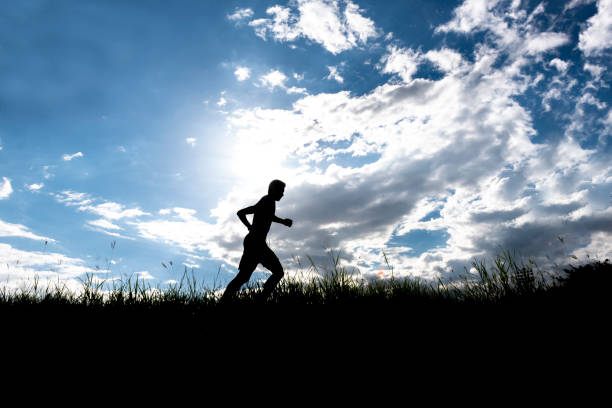 istock Men running outdoor on silhouette background. 1034027098