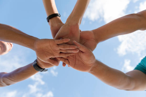 istock People use hand coordination to express their collective strength. 1034027218