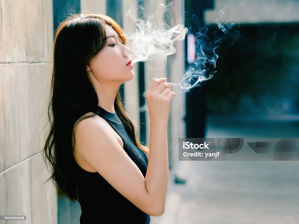Portrait Of Beautiful Chinese Girl Smoking Outdoor And Thinking About  Problems Seems A Little Bit Lost In Vintage Mode Stock Photo - Download  Image Now - iStock