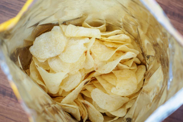 istock Potato chips in open snack bag close up 1034035212