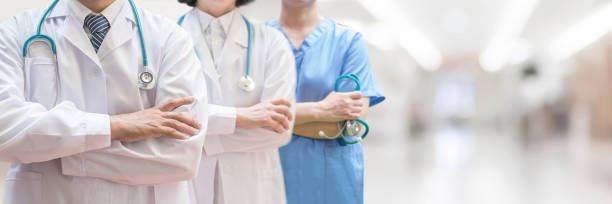 Doctor and surgeon professional team with medical clinic background for nursing care professional teamwork and patient trust in hospital ER and clinic concept Doctor and surgeon professional team with medical clinic background for nursing care professional teamwork and patient trust in hospital ER and clinic concept doctor lifestyle stock pictures, royalty-free photos & images