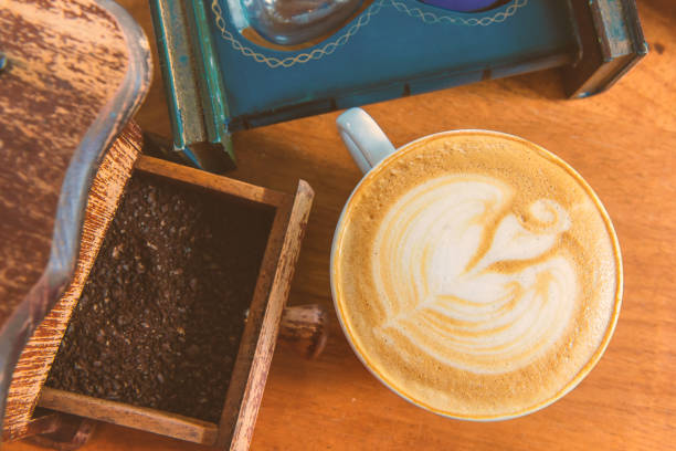 istock latte art coffee or cappuccino on wooden table background 1034036272