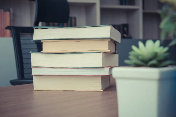 istock Pack of Book stack on table in working room at office, Vintage style 1034036400