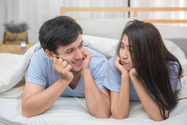 istock Young couple sleeping and relaxing on the bed in bedroom 1034036678
