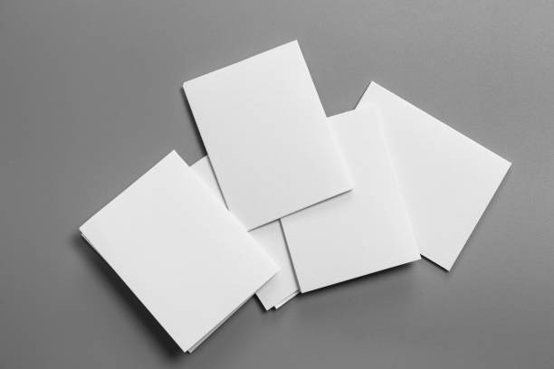 istock Blank portrait mock-up paper. brochure magazine isolated on gray, changeable background / white paper isolated on gray 1034060574