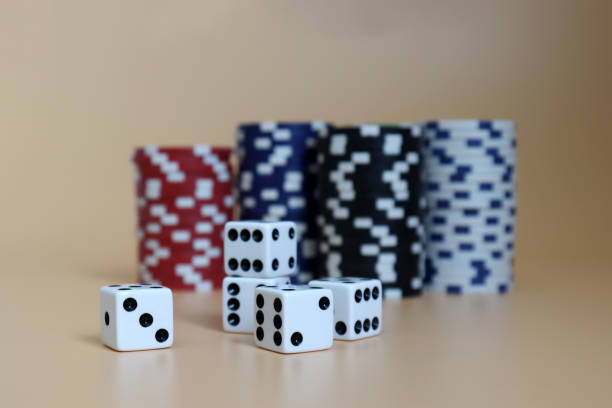 istock Five dice with the pile of casinos chips. 1034062738
