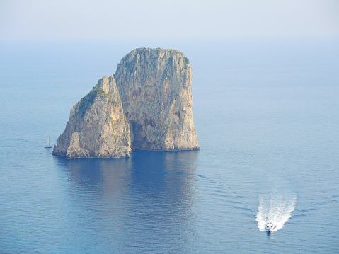 Capri, Naples, Campania area, Italy. The beautiful and well known Faraglioni. The three spurs of rock which rise up out of the sea in a wonderful day