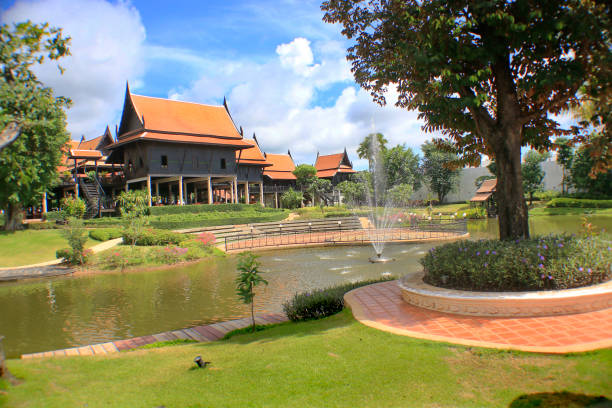 istock Thai style house with garden and sky backdrop. 1034107890