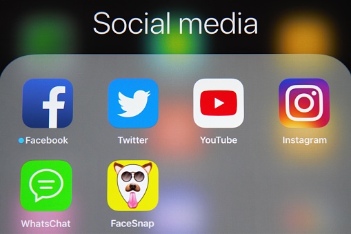 Various social media apps, including YouTube, Facebook, Twitter, WhatsApp and Instagram are grouped under a Social Media heading on an Apple iPad tablet screen.