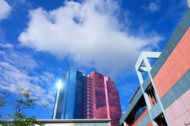 istock Pink and blue windows architecture building with blue sky and white cloud 1034110610