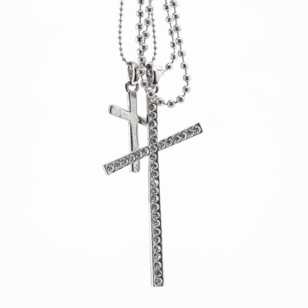 istock Silver christian cross necklace isolated on white 1034125596