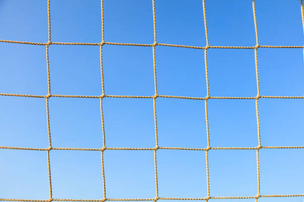 Football net closeup on blue sky background