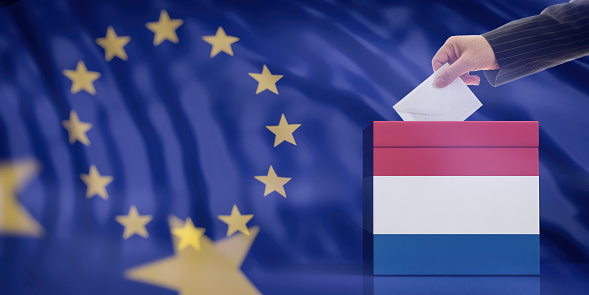 Elections in Netherlands for EU parliament. Hand inserting an envelope in a Dutch flag ballot box on European Union flag background. 3d illustration