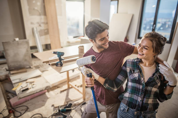 istock Happy embraced couple talking during home renovation process. 1034143994