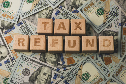 Tax Refund concepts. Tax Refund characters and US currency notes.
Tax Return.