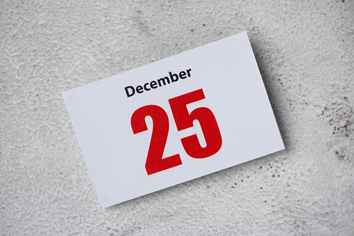 Object, White wooden note board and cube block with show date 24 december with space for text on white background. Remind for christmas holiday concept.