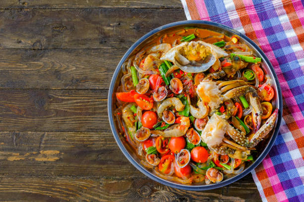 istock Som Tam Seafood (Spicy Papaya Salad) with salted crab, on wooden table ( Thai food) 1034148996