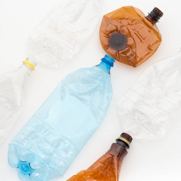 istock Different types of crushed plastic bottles on white background. Recyclable waste. Recycling, reuse, garbage disposal, resources, environment and ecology concept. 1034152208