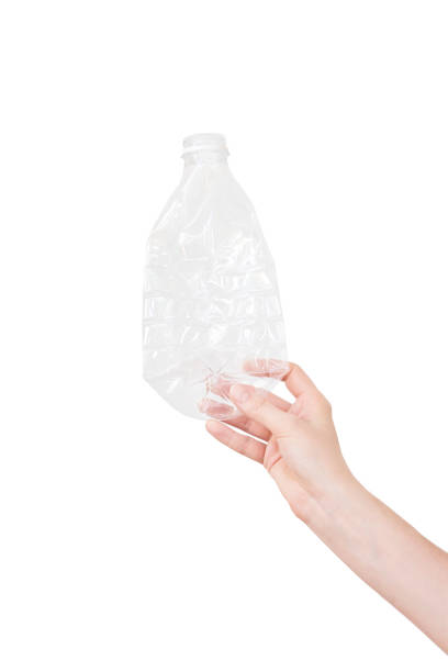 istock Female hand holding empty crushed plastic bottle isolated on white. Recyclable waste. Recycling, reuse, garbage disposal, resources, environment and ecology concept 1034152356
