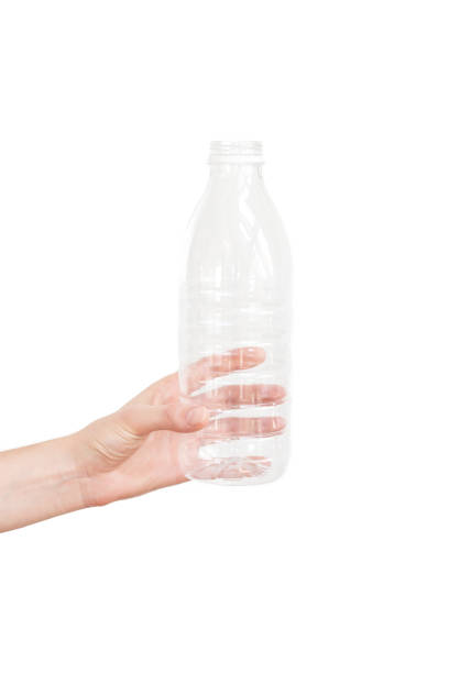istock Female hand holding empty plastic bottle isolated on white. Recyclable waste. Recycling, reuse, garbage disposal, resources, environment and ecology concept 1034152362