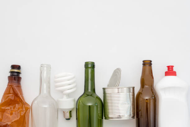 istock Recyclable waste, resources. Clean glass, paper, plastic and metal on white background. Copyspace for text. Recycling, reuse, garbage disposal, resources, environment and ecology concept 1034152394