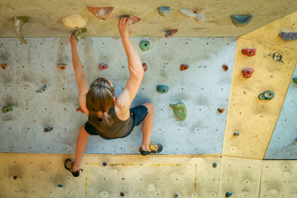 istock Teenage Boy Training Climbing On Indoor Climbing Wall 1034184278