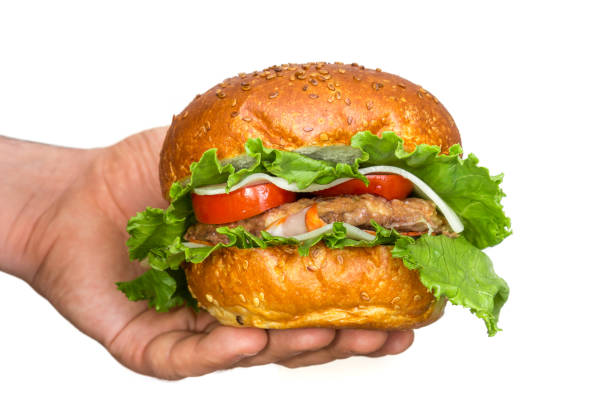 istock American burger in hand isolated on white 1034192264