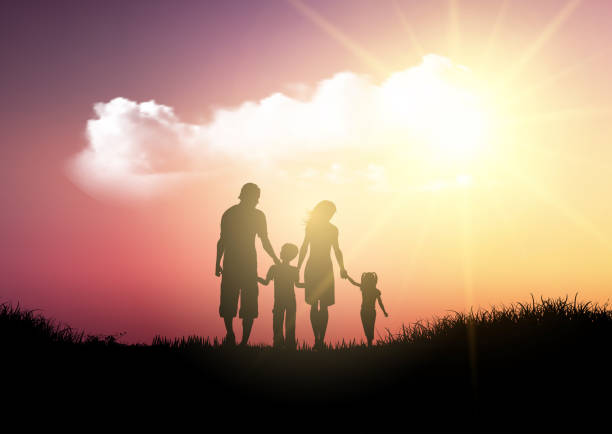 istock Silhouette of a family walking against a sunset sky 1034195126