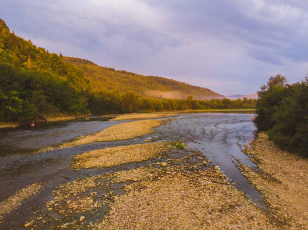 istock landscape view, mountains on sunset with fig and river 1034199448