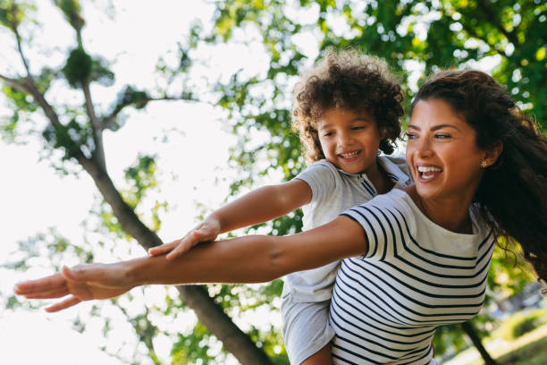 istock Mother piggybacking son at park 1034202142
