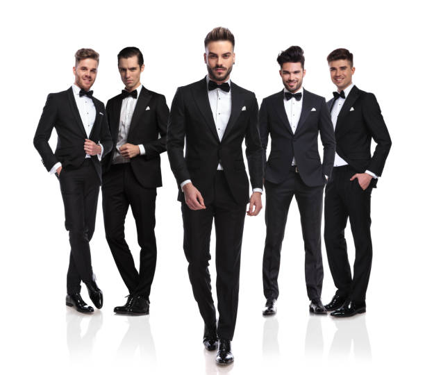 istock elegant young groom walks in front of his group 1034207658