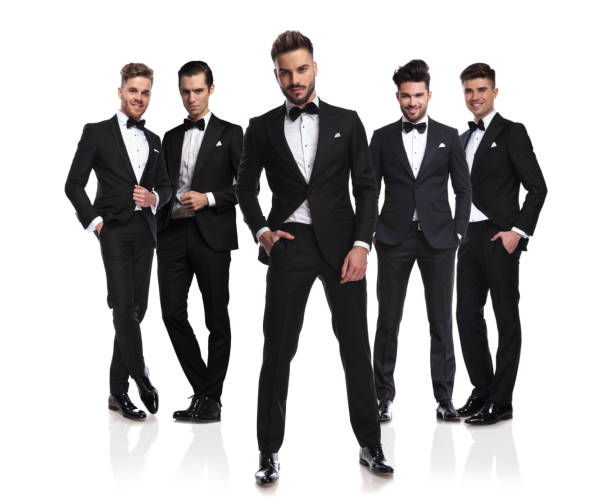 istock five elegant grooms in tuxedoes with relaxed leader in front 1034207670