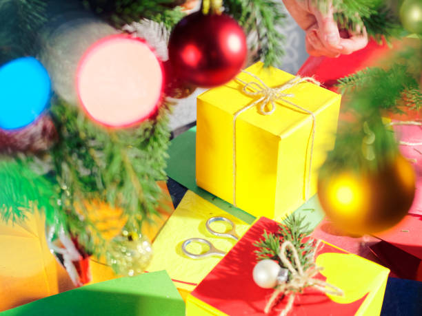 istock Wrapping Christmas presents under the Christmas tree 1034212116