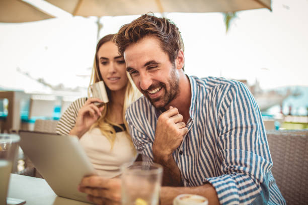 istock Happy couple checking menu at the tablet 1034212214