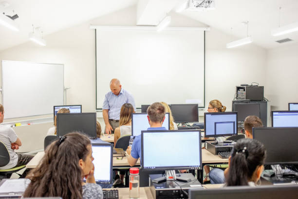 istock Professor and Adult Students Having Class in Computer Classroom 1034212398