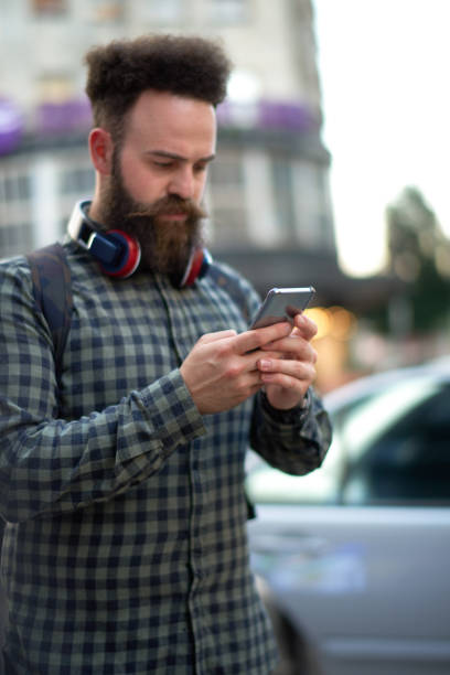 istock Male hipster person with mobile phone 1034217432