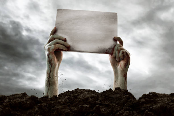 Zombie hands holding blank sign Zombie hands holding blank sign zombie paper stock pictures, royalty-free photos & images