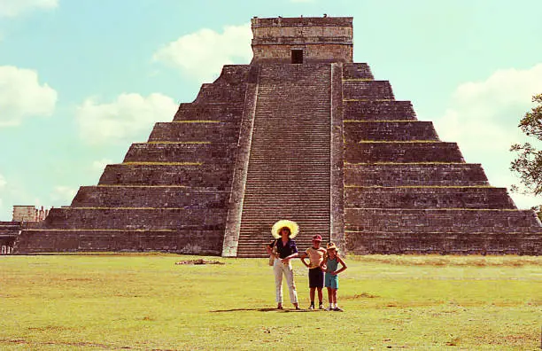Vintage image of a family visit to El Castillo pyramid in Chichen Itza, Mexico.