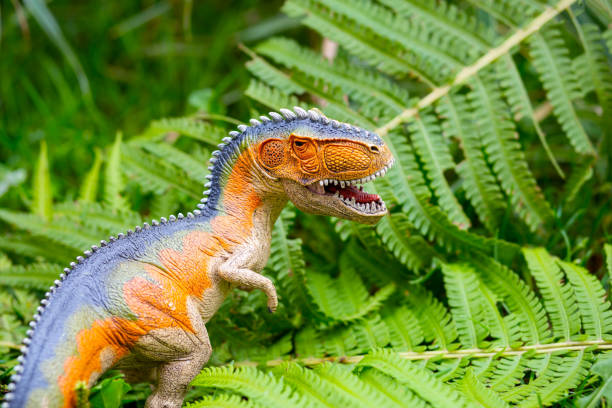 istock Dinosaur with large teeth in the jungle. Dinosaur model 1034228390