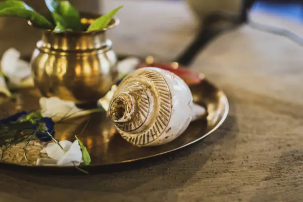 Conch Shell with selective focus on a decorative puja thali.