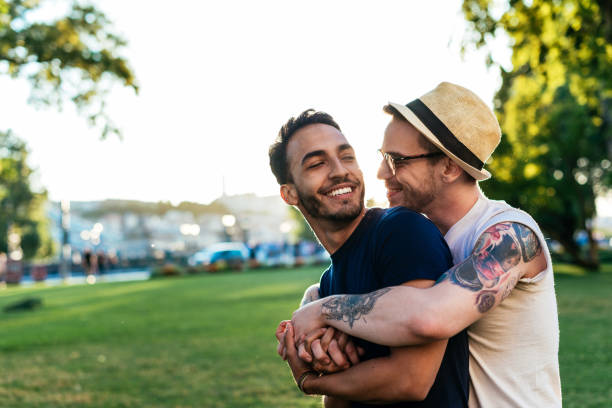 Young gay couple showing emotions Young gay men on city break in early summer, visiting Central Europe and having fun together gay man photos stock pictures, royalty-free photos & images