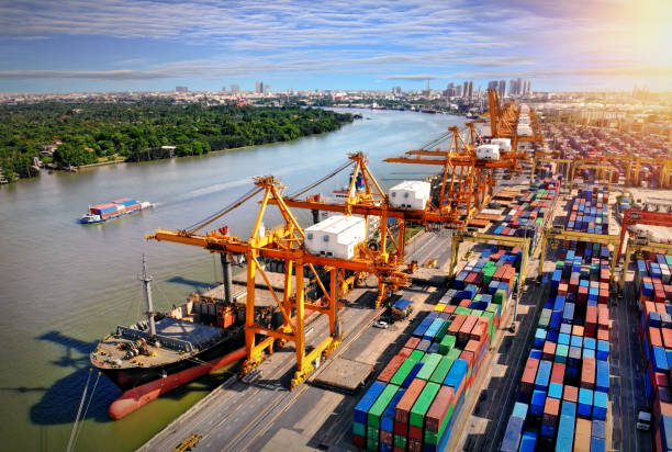 istock Logistics and transportation of Container Cargo ship and Cargo plane with working crane bridge in shipyard at sunrise, logistic import export and transport industry background 1034232072