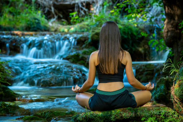 istock Woman meditating in forest 1034233028
